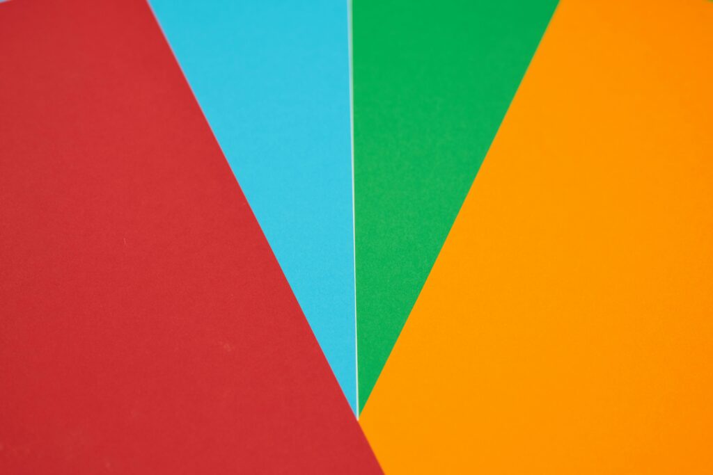 Colorful abstract design featuring red, blue, green, and orange geometric shapes.